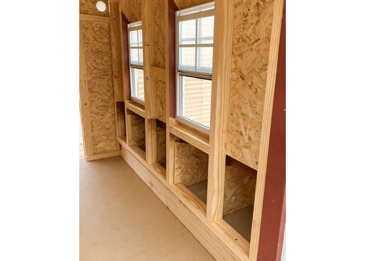 Inside the large chicken coop showing the nesting box openings