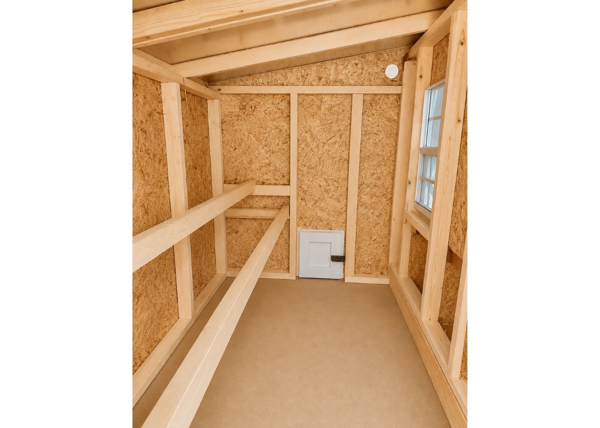 Inside the large chicken coop with roost bars and windows