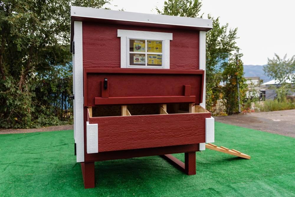 Red medium chicken coop with white trim, with nesting box open