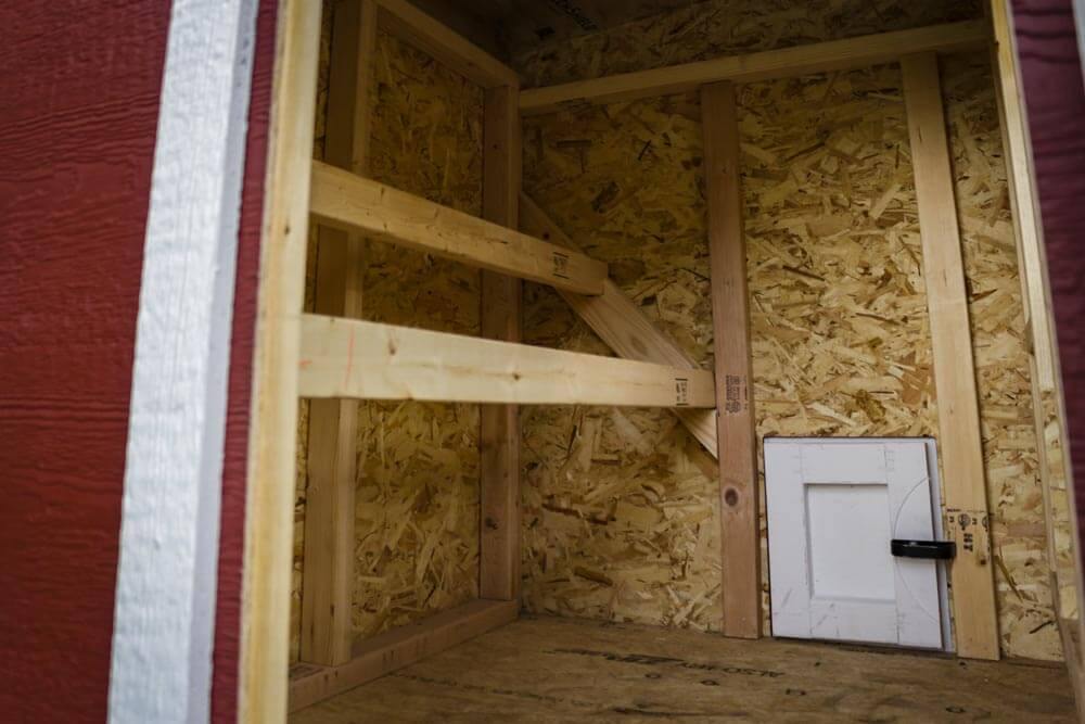 Inside the medium chicken coop with roost bars and windows