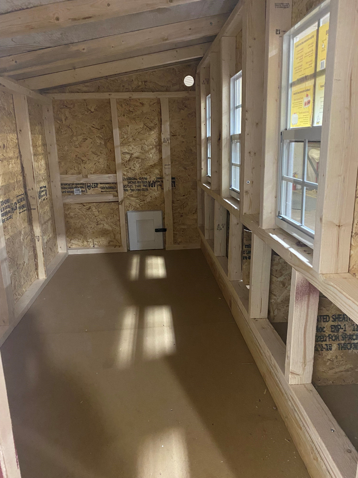 Interior of the XL chicken coop with windows and nesting box openings