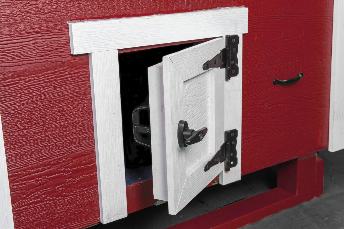 Red large chicken coop with white trim, close-up of the chicken pop door