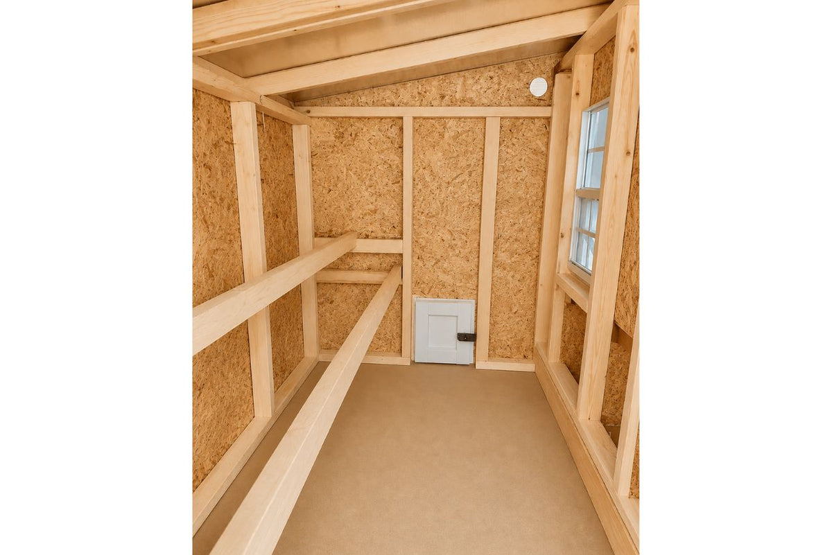 Inside the large chicken coop with roost bars and windows