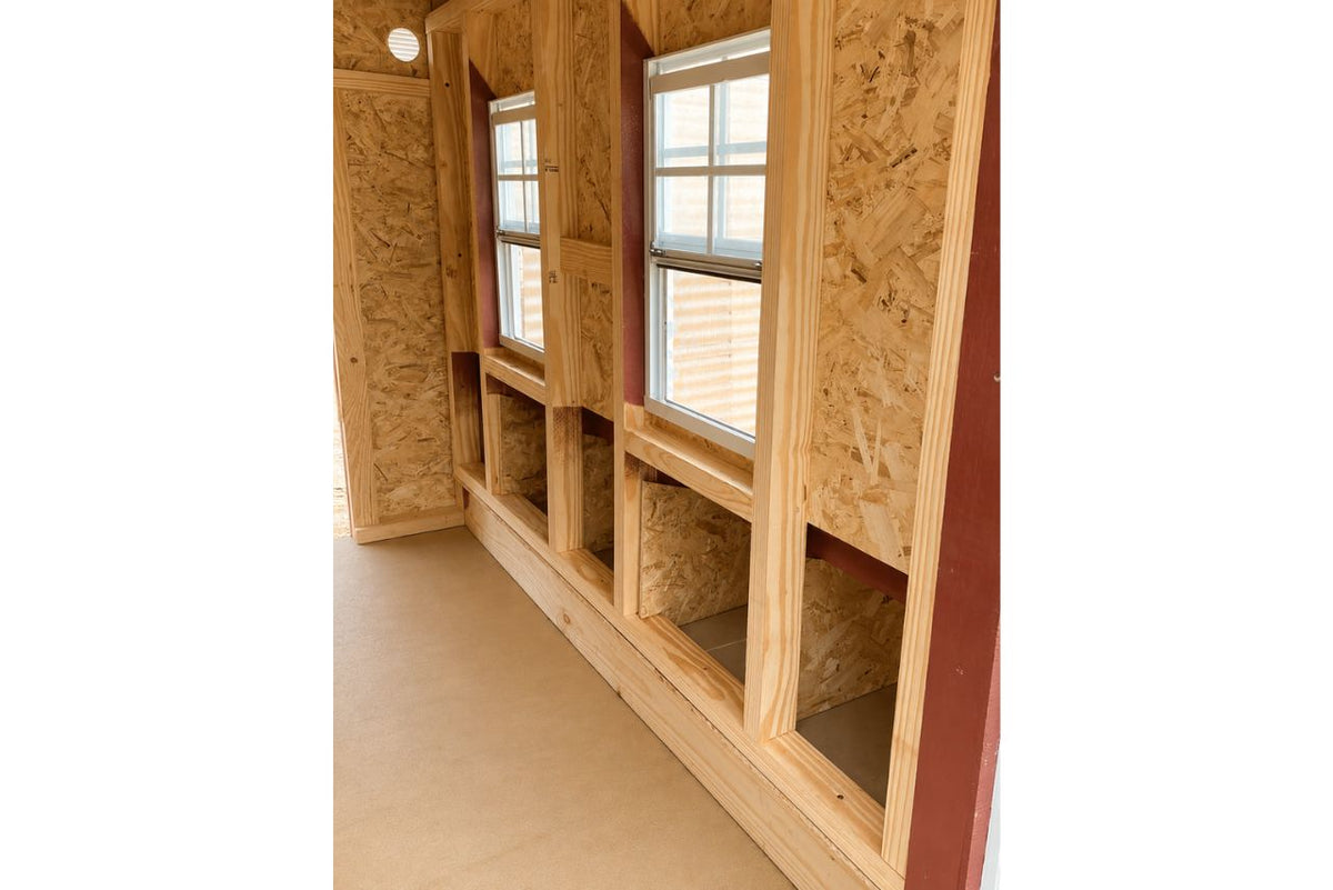Inside the large chicken coop showing the nesting box openings