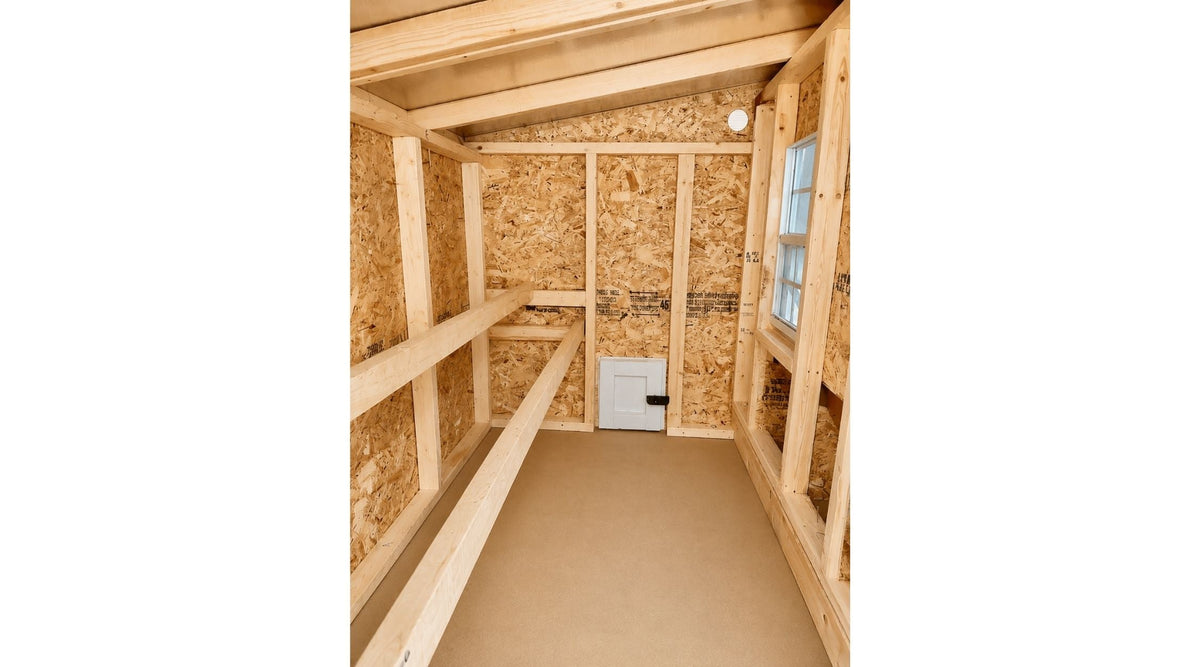 Inside the large chicken coop with roost bars and windows