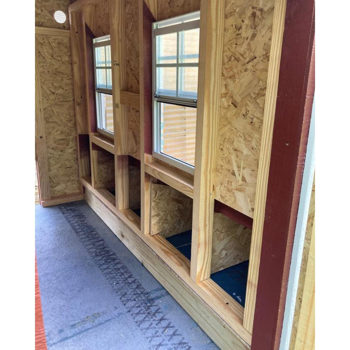 Inside the large chicken coop showing the nesting box openings