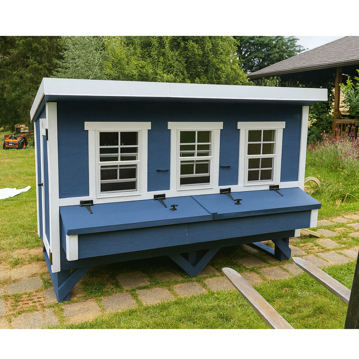 Blue XL chicken coop with white trim, set up in a backyard